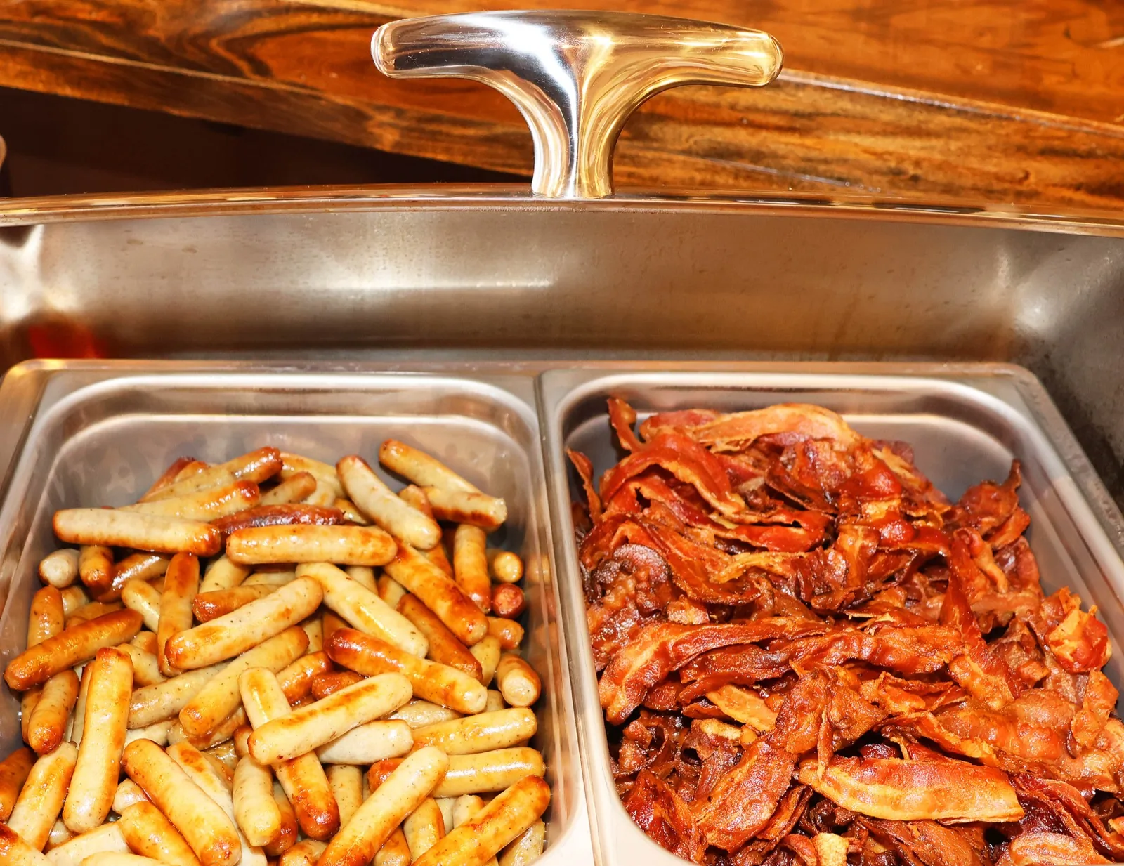 Breakfast sausage and crispy bacon in chafing dishes at Sunday brunch at The Venue Clermont